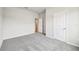 Empty bedroom featuring plush gray carpeting, neutral walls, and natural light at 6087 Sacred Oak Ave, Mount Dora, FL 32757