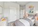 Comfortable bedroom features twin beds, neutral bedding, and simple decor at 6087 Sacred Oak Ave, Mount Dora, FL 32757