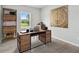Bright home office features modern desk, shelving, and neutral tones for a serene workspace at 6087 Sacred Oak Ave, Mount Dora, FL 32757