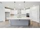 Bright kitchen showcases a large island, stainless steel appliances, and stylish pendant lighting at 6087 Sacred Oak Ave, Mount Dora, FL 32757