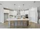 Bright kitchen boasts a large island, stainless steel appliances, and stylish pendant lighting at 6087 Sacred Oak Ave, Mount Dora, FL 32757