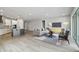 Open-concept living room with modern furnishings and seamless connection to the kitchen at 6087 Sacred Oak Ave, Mount Dora, FL 32757