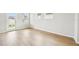 Light-filled living room with durable floors, large windows, and access to backyard at 6087 Sacred Oak Ave, Mount Dora, FL 32757