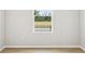 Bright empty room featuring natural light and wood laminate flooring at 6087 Sacred Oak Ave, Mount Dora, FL 32757