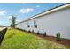 Newly installed grass in the side yard showing a partial side view of the house at 6087 Sacred Oak Ave, Mount Dora, FL 32757