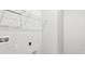 An empty utility room with a metal shelf, electrical outlets, and water shut off access panel at 6087 Sacred Oak Ave, Mount Dora, FL 32757