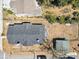 Aerial view of the house showcasing a dark gray roof and detached garage in a tree-sparse yard at 701 N Vermont Ave, Lakeland, FL 33801