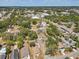 Aerial view featuring rooftops of houses and lush trees in a residential area at 701 N Vermont Ave, Lakeland, FL 33801