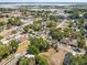 Wide aerial shot of a neighborhood with tree-lined streets near a body of water at 701 N Vermont Ave, Lakeland, FL 33801