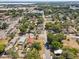 Aerial view with a green arrow illustrating a home's positioning within a classic neighborhood with tree coverage at 701 N Vermont Ave, Lakeland, FL 33801