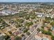 Scenic aerial view shows rooftops amongst trees in a neighborhood near downtown at 701 N Vermont Ave, Lakeland, FL 33801