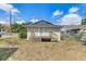 Backyard view of the home with a small porch and staircase at 701 N Vermont Ave, Lakeland, FL 33801