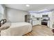 Studio bedroom features a bed, stainless steel refrigerator, and small white kitchen at 701 N Vermont Ave, Lakeland, FL 33801