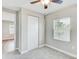 This cozy carpeted bedroom features a ceiling fan, closet and window for natural light at 701 N Vermont Ave, Lakeland, FL 33801