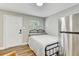Bedroom features a bed, window, and stainless steel refrigerator at 701 N Vermont Ave, Lakeland, FL 33801