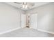 Bright bedroom featuring neutral carpet, a ceiling fan, and white trim on the walls at 701 N Vermont Ave, Lakeland, FL 33801