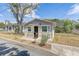 Quaint home featuring a neutral exterior, fenced yard, and mature landscaping at 701 N Vermont Ave, Lakeland, FL 33801