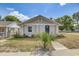Charming home featuring a covered entry, neutral exterior, and simple landscaping at 701 N Vermont Ave, Lakeland, FL 33801
