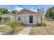 Charming home featuring a covered entry, neutral exterior, and simple landscaping at 701 N Vermont Ave, Lakeland, FL 33801