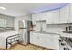 Bright kitchen with white cabinets, subway tile backsplash, and stainless steel refrigerator at 701 N Vermont Ave, Lakeland, FL 33801
