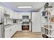 Modern kitchen with white cabinets, stainless steel appliances, and stylish backsplash at 701 N Vermont Ave, Lakeland, FL 33801