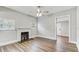 Bright living room with fireplace, wood floors, and ceiling fan at 701 N Vermont Ave, Lakeland, FL 33801