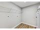 Spacious utility room with wood-look flooring, shelving, and washer/dryer hookups at 701 N Vermont Ave, Lakeland, FL 33801