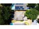 Overhead shot of the home's roof and private pool, as well as the solar panels and the surrounding yard at 1142 Mariner Cay Dr, Haines City, FL 33844