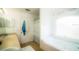 Bright bathroom featuring a soaking tub with an arched window and a vanity with dual sinks at 1142 Mariner Cay Dr, Haines City, FL 33844