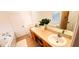 Spacious bathroom featuring a double vanity, large mirror, and decorative floral arrangement at 1142 Mariner Cay Dr, Haines City, FL 33844