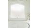 Clean bathtub next to a frosted window with a candle and floral arrangement at 1142 Mariner Cay Dr, Haines City, FL 33844