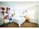 Cozy bedroom with vibrant decor, including colorful wall decorations, a comfortable bed, and a functional desk space at 1142 Mariner Cay Dr, Haines City, FL 33844