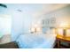 Bright bedroom with a queen bed, simple decorations, and side tables with lamps at 1142 Mariner Cay Dr, Haines City, FL 33844