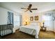 Bright bedroom with a ceiling fan, cozy furniture, and natural light from large windows at 1142 Mariner Cay Dr, Haines City, FL 33844