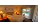Comfortable bedroom with a king-size bed and a view of the pool area through sliding glass doors at 1142 Mariner Cay Dr, Haines City, FL 33844