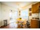 Sunlit breakfast nook with a round table, white chairs, and a view of the outdoor patio at 1142 Mariner Cay Dr, Haines City, FL 33844