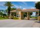 Mediterranean-style gated community entrance with palm trees and lush landscaping at 1142 Mariner Cay Dr, Haines City, FL 33844