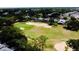 Aerial view showcasing the well-manicured golf course surrounded by lush landscaping and residential properties at 1142 Mariner Cay Dr, Haines City, FL 33844