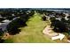 Beautiful aerial view of a lush green golf course with sand traps and mature trees at 1142 Mariner Cay Dr, Haines City, FL 33844