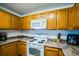 A well-equipped kitchen featuring modern appliances, wooden cabinets, and granite countertops at 1142 Mariner Cay Dr, Haines City, FL 33844