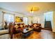 Cozy living room with comfortable leather seating, neutral walls, tile floor and natural light at 1142 Mariner Cay Dr, Haines City, FL 33844