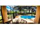 Screened-in pool area with outdoor furniture and lush landscaping, great for outdoor fun at 1142 Mariner Cay Dr, Haines City, FL 33844
