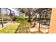 Exterior of screened-in pool area with access to the yard and surrounded by mature trees and greenery at 1142 Mariner Cay Dr, Haines City, FL 33844