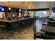 Upscale bar/restaurant featuring a dark granite bar with stools, tables, and expansive windows at 1142 Mariner Cay Dr, Haines City, FL 33844