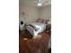 Well-lit bedroom with hardwood floors and a full sized bed at 14845 Huntley Dr, Orlando, FL 32828