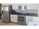 Modern kitchen featuring stainless steel appliances, white cabinets, and stone backsplash at 14845 Huntley Dr, Orlando, FL 32828