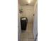 Tiled laundry room with washer, dryer, shelving, and utility closet at 14845 Huntley Dr, Orlando, FL 32828