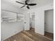 Bedroom with wood-look floors, ceiling fan, and windows offers bathroom access at 3043 Sego Ln, Lakeland, FL 33801