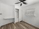 Bright bedroom features wood-look floors, ceiling fan, window, and closet at 3043 Sego Ln, Lakeland, FL 33801