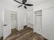 Bedroom boasts wood-look floors, ceiling fan, closet, and access to bathroom at 3043 Sego Ln, Lakeland, FL 33801